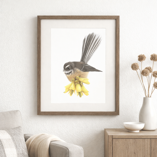 Fantail perched on kōwhai flowers, fine art print framed in medium brown wood, styled in a Scandinavian interior.”