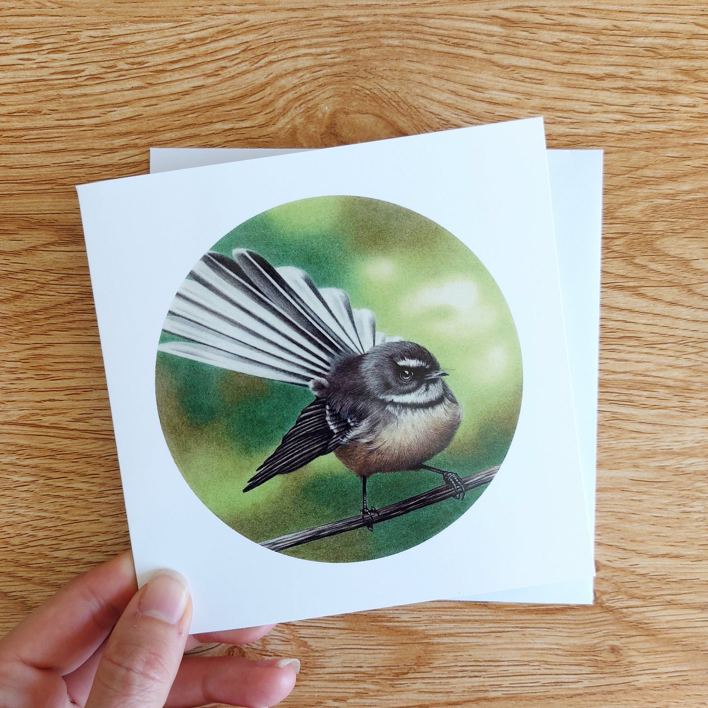 Greeting card featuring a coloured pencil illustration of a New Zealand fantail piwakawaka