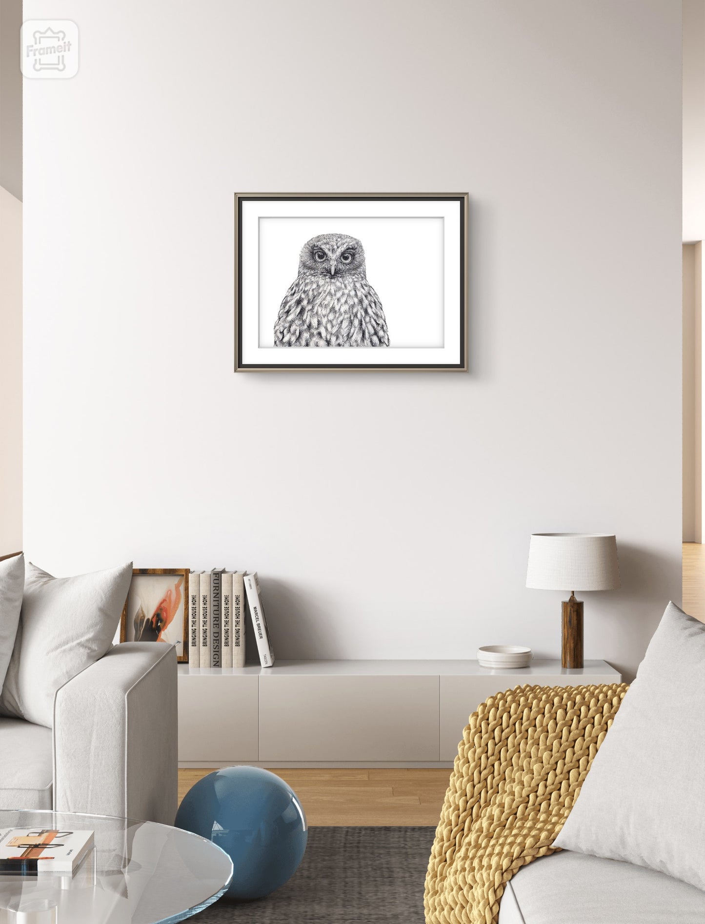 Morepork black and white graphite art print displayed in a minimalist interior setting